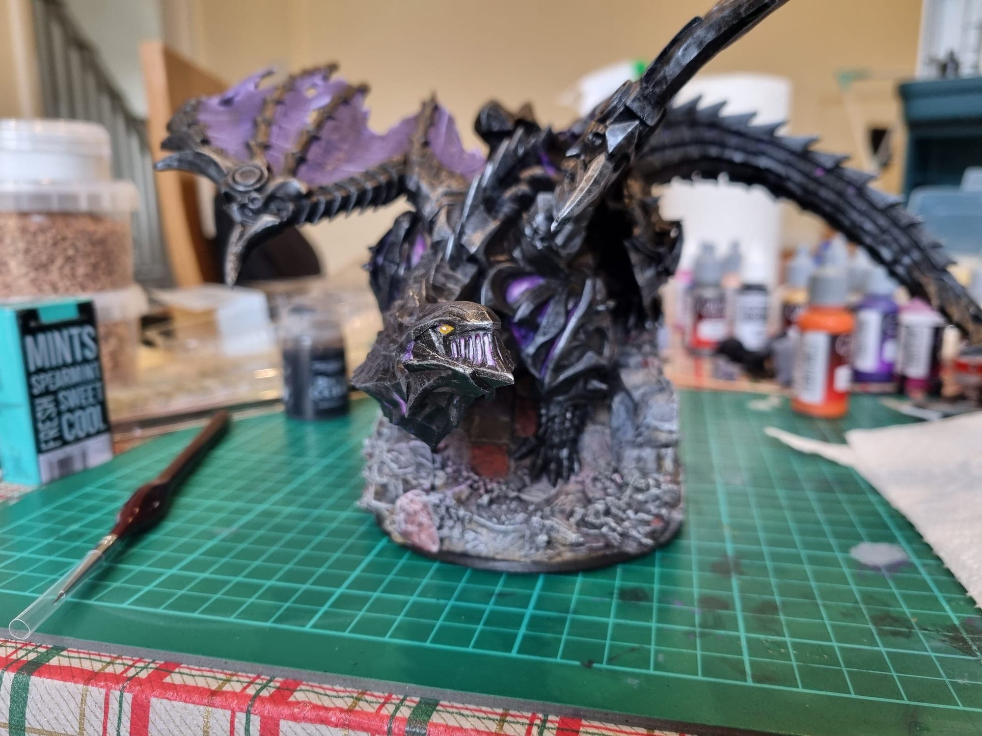 The dragon on its rocky base, front three-quarters.