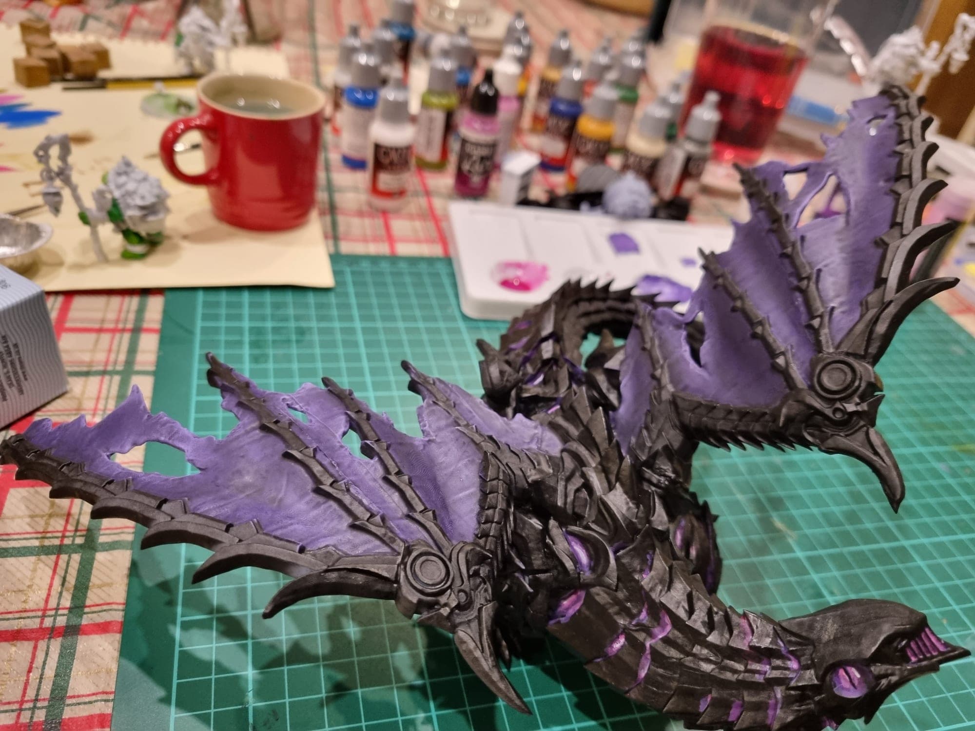The part-painted dragon laid on the mat.