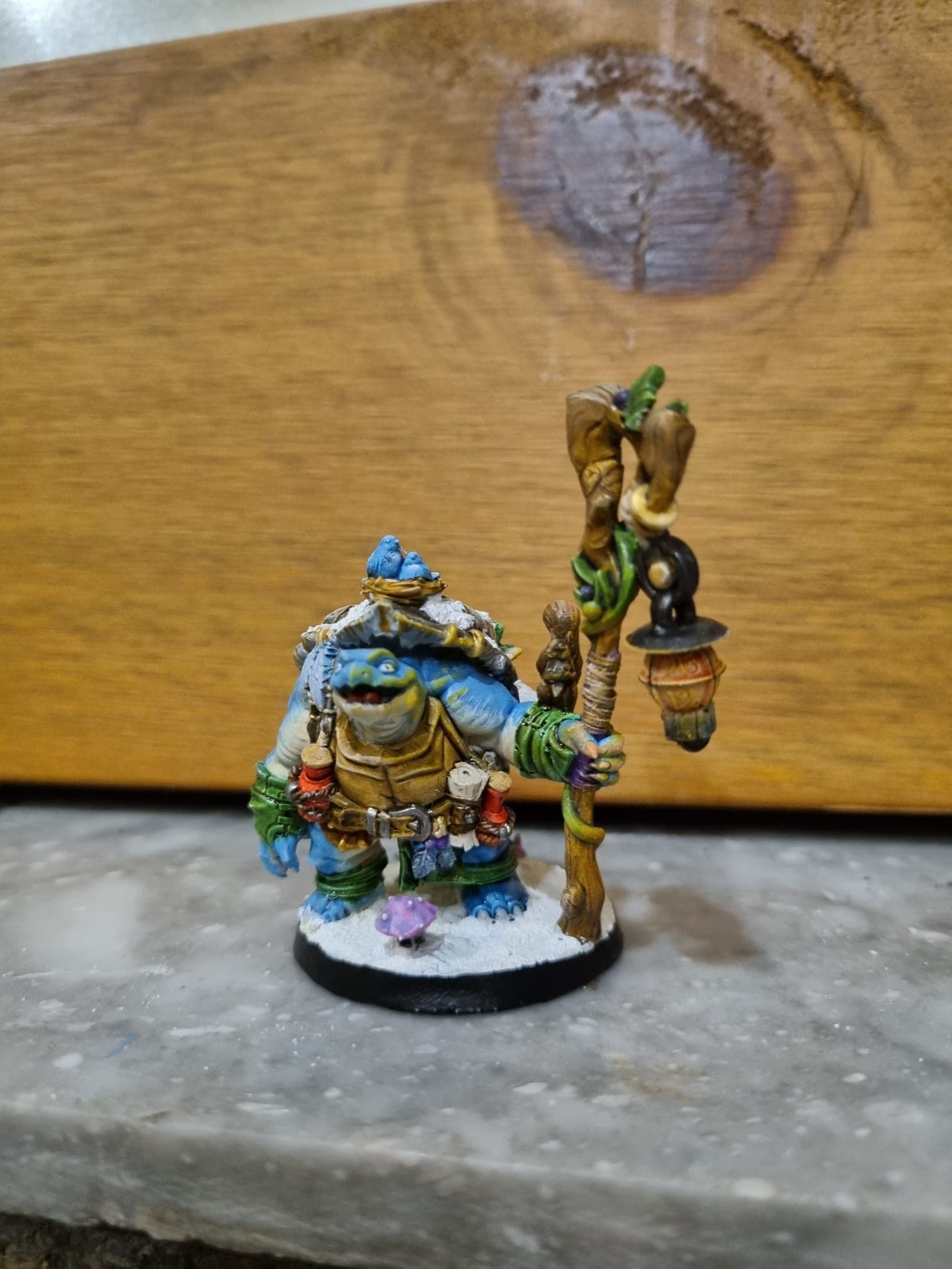 Snow-laden pack turtle with a lantern staff.